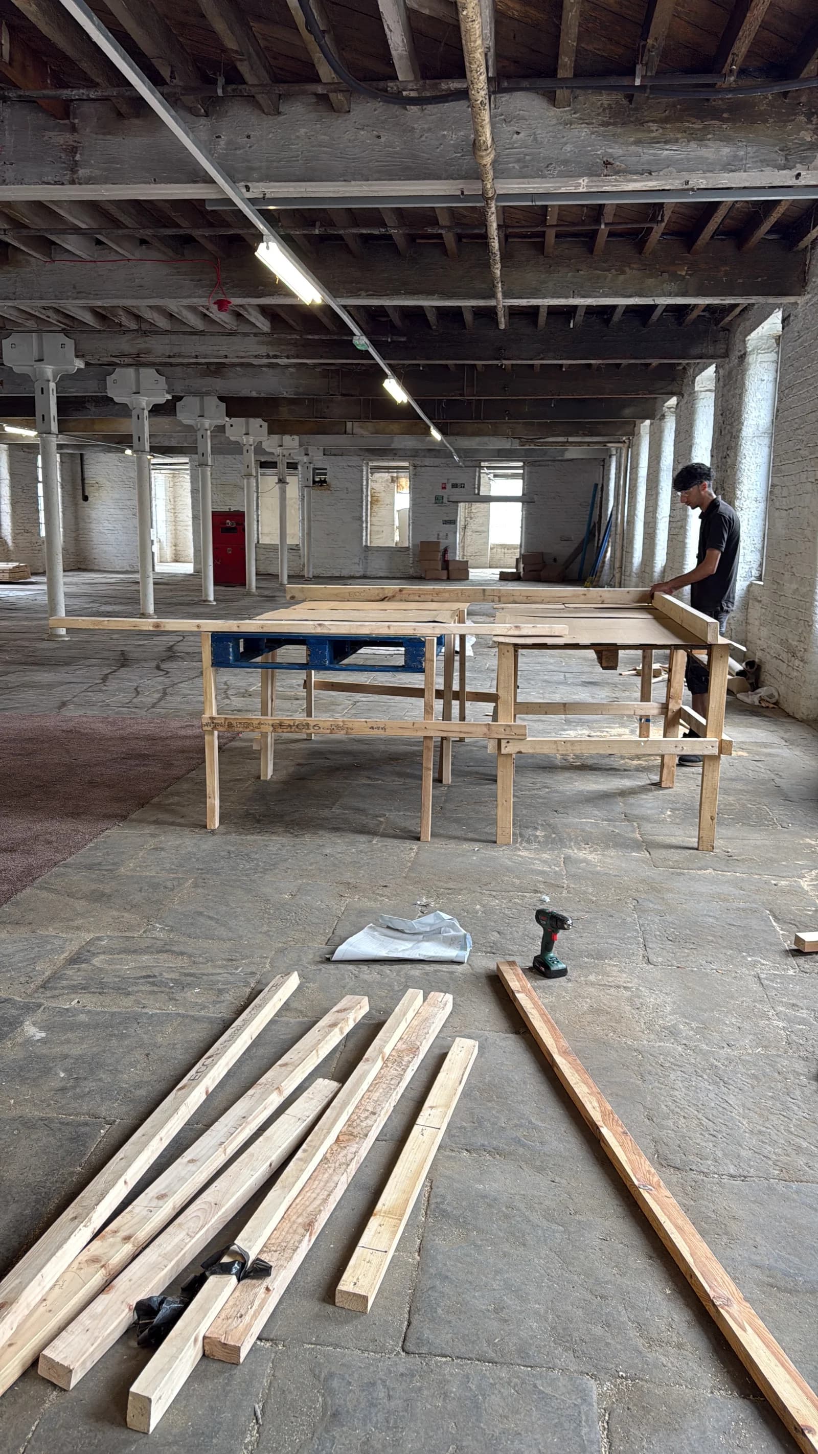 Timber materials and a workbench inside North Dean Mill
