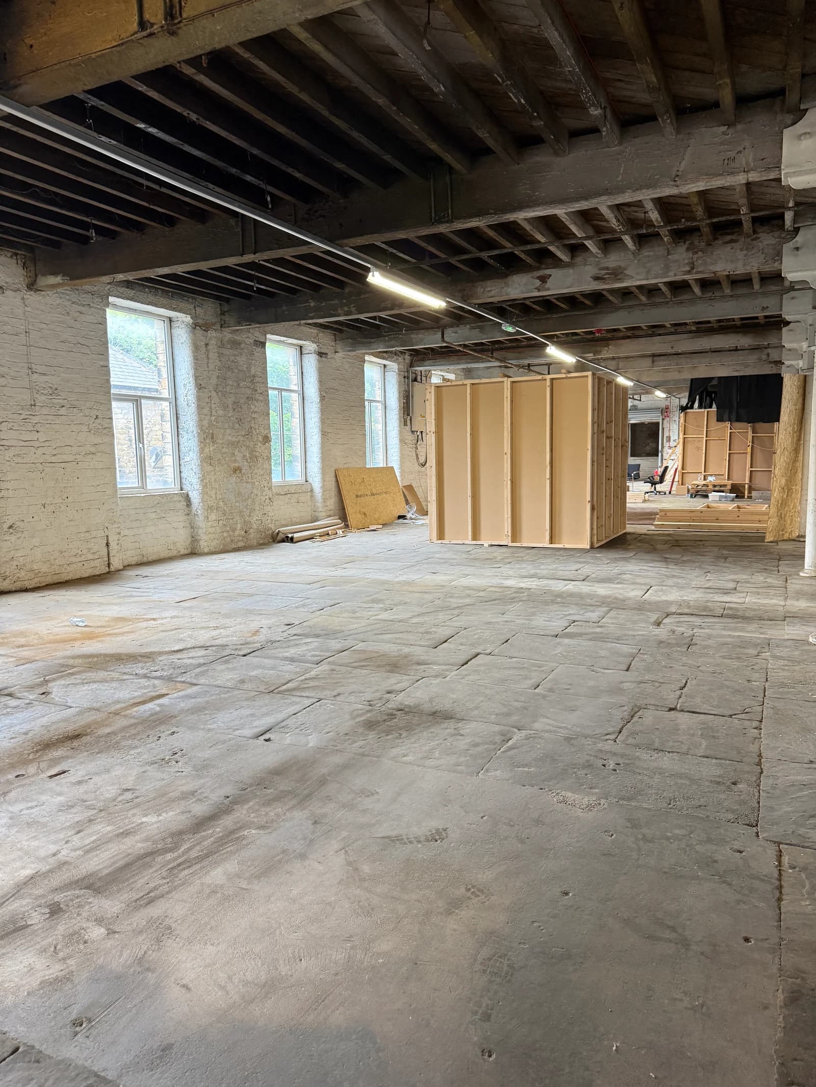 Timber studio partitions under construction inside the mill