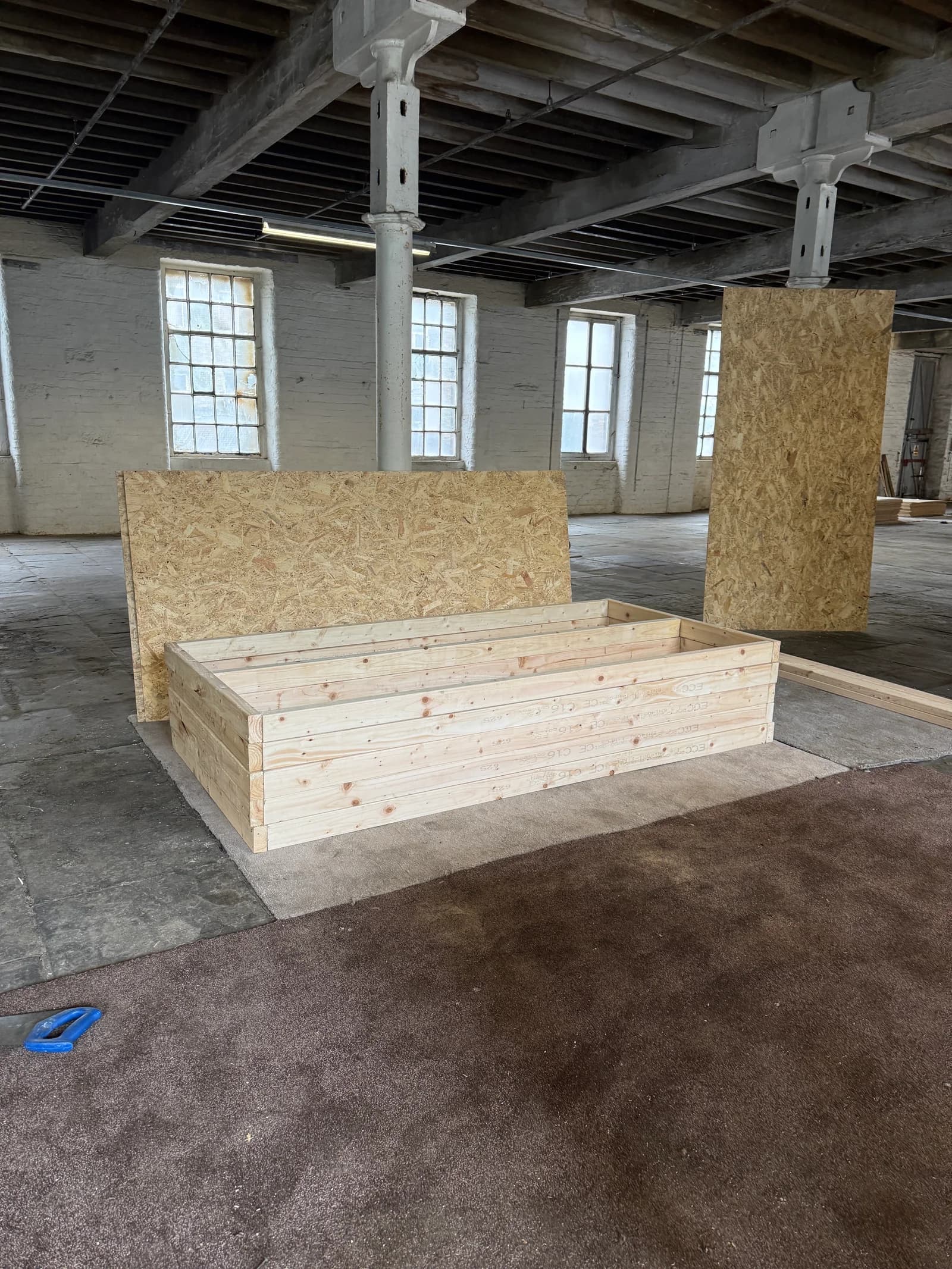 Timber platforms and partitions being assembled for the studio bays