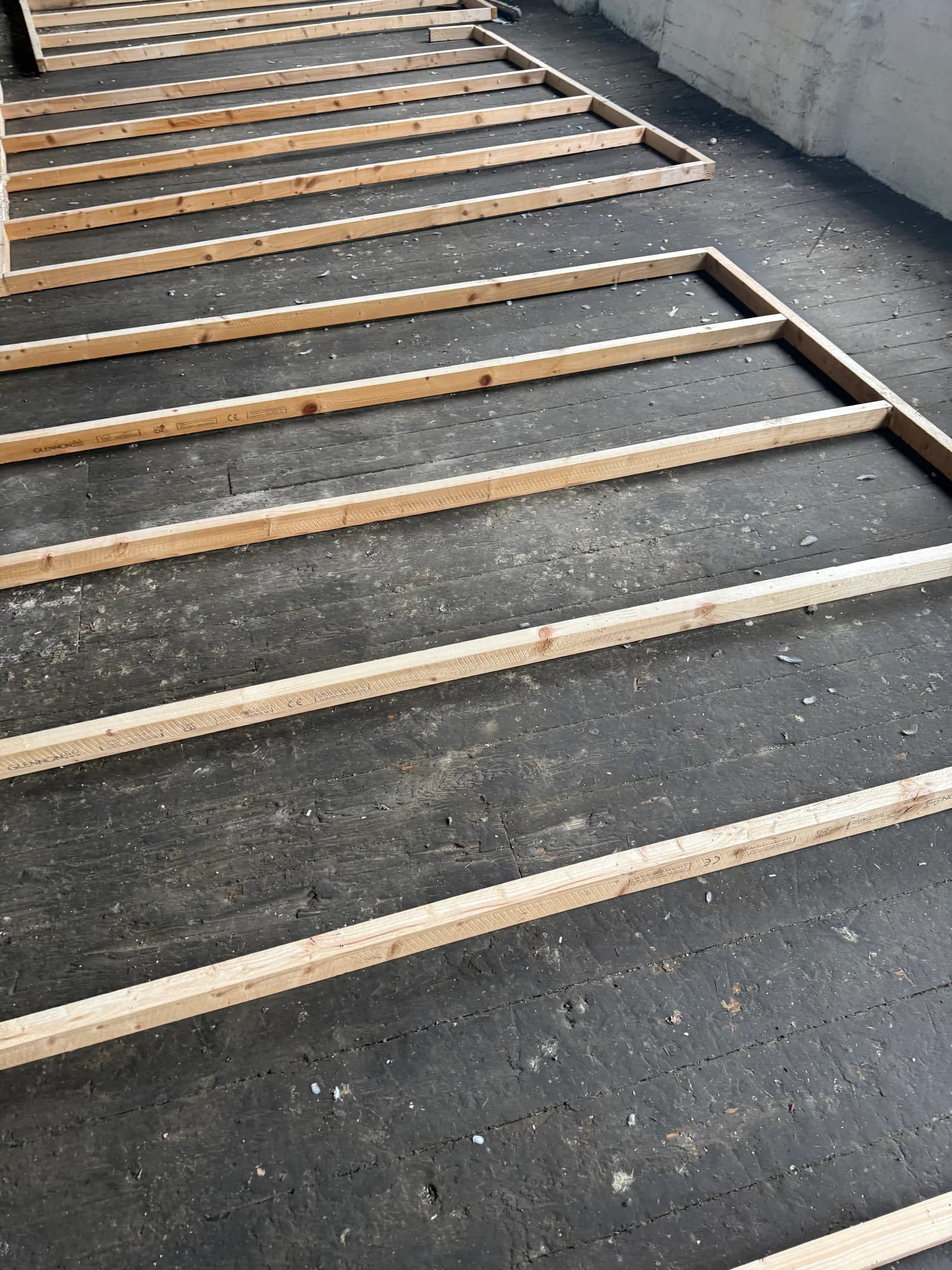 Timber floor framing being laid inside the mill