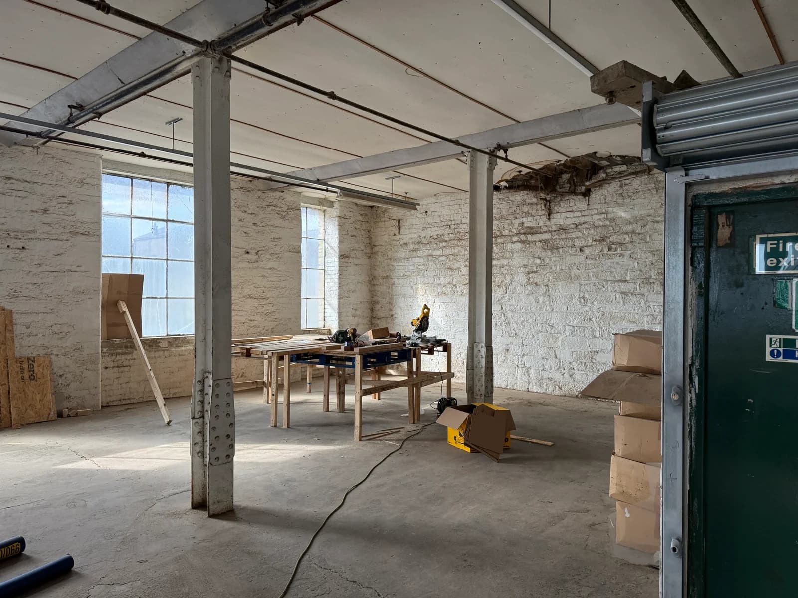 A workbench and materials beside the original mill pillars
