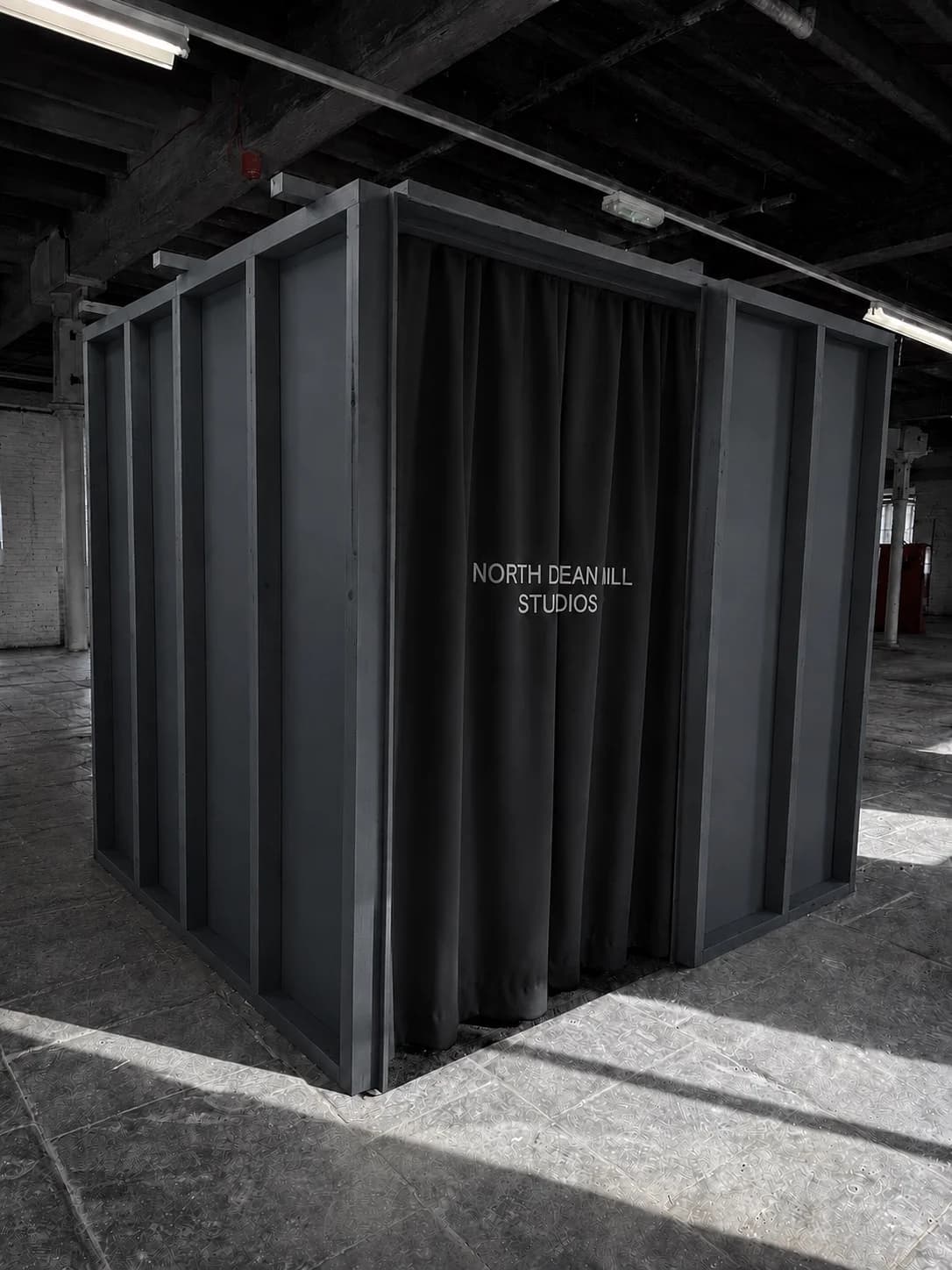 An individual black TikTok Live pod with a branded curtain entrance