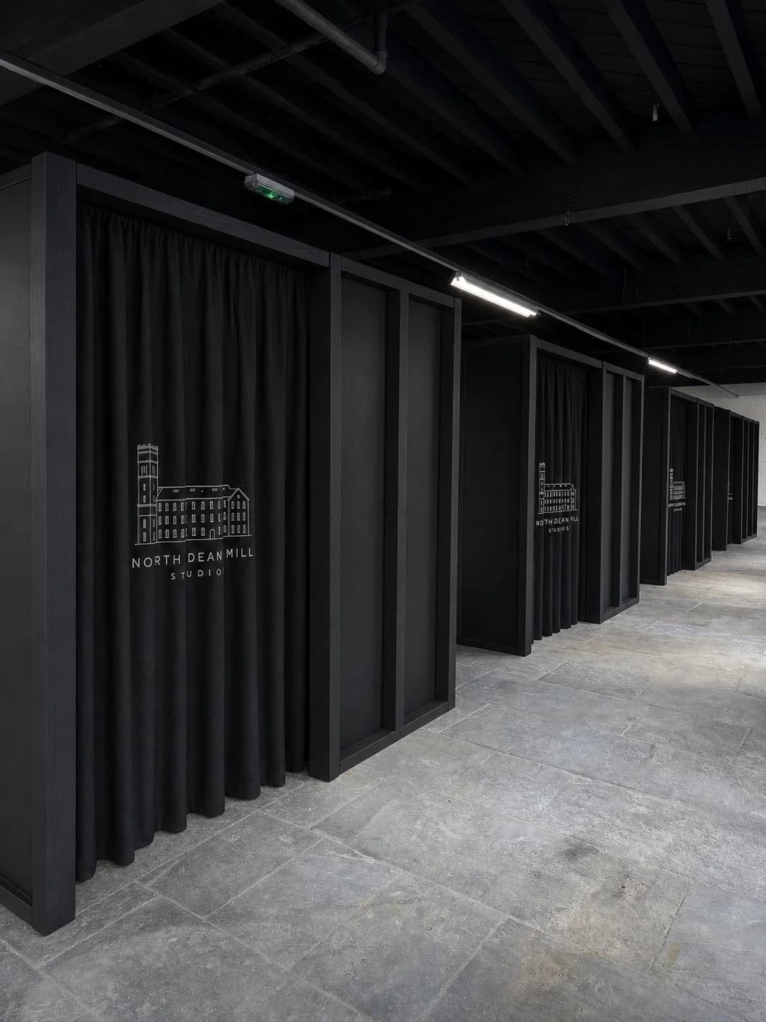 A row of black TikTok Live pods with North Dean Mill embroidered curtains